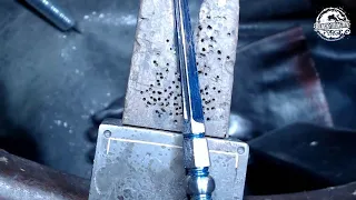 Hand cutting fullers on a tri-edged stiletto dagger