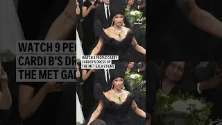 Nine men carry Cardi B’s dress up the Met Gala stairs