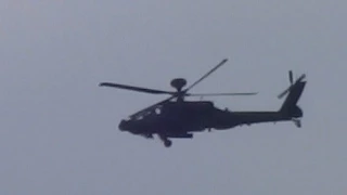 2 apache helicopters fly over