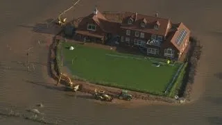 Floods in Somerset: Island house as owner builds makeshift flood barricade