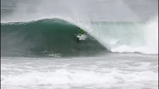 Surfers riding chaotic and beautiful big waves