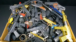 Box of Toy Guns, Real Knives And Karambit Knives. Revolver Toy Guns