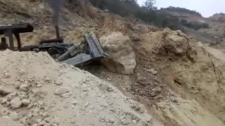 Pushing huge boulder off hill!