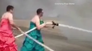 Firefighters in drag put out fire