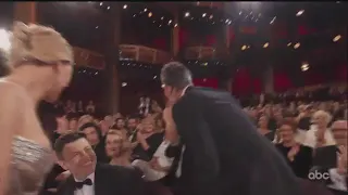 Taika Waititi winning his Oscar and hugging Scarlett Johansson