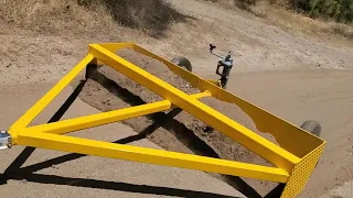 homemade box grader on hard dirt road