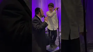 Lipa Schmeltzer performs with his son on stage ft. Yossi Shtendig