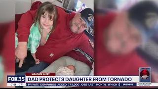 Dad protects daughter from tornado