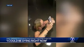 Man, friends stuck in elevator as it fills with water