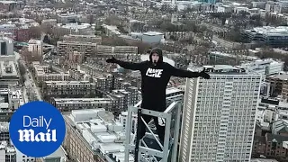 Urban explorers are battered by hailstones as they scale London tower