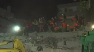 Rescuers search through rubble of quake aftermath