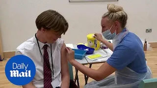 School children receive COVID-19 vaccines at school in England