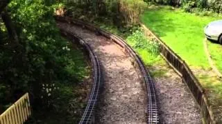 9f passes under a footbridge at the mold minature railway