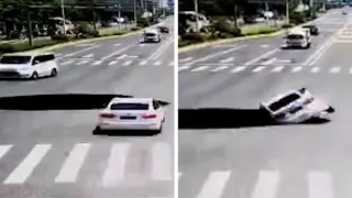 Car falls down giant hole on road in China