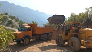 Loading Volvo L120 and Benz trucks, and driving on mountain roads,2024