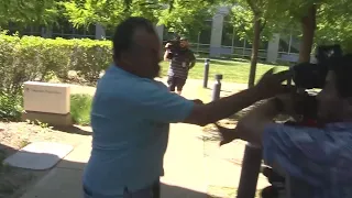 School crossing guard charged with assault violently confronts photographers outside court