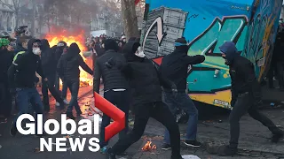 Tear gas, fires as thousands protest in Paris against police violence, security bill