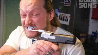 Guy Brushing His Teeth With A Pistol