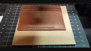 Laser engraving a leather wallet.
