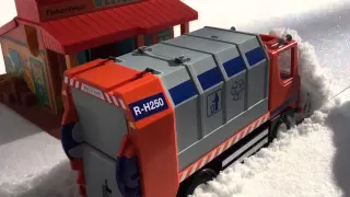 Garbage truck plowing snow