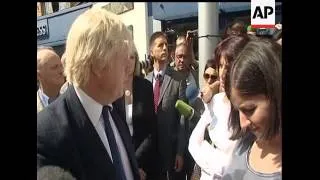 Mayor of London Boris Johnson is heckled by onlookers as he speaks with members of the press while t