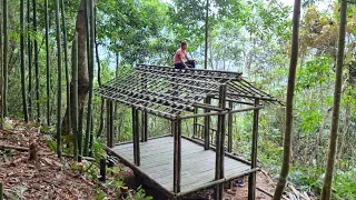 Everyone is invited to watch the girl make a bamboo house roof frame and erect a palm leaf roof