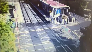 Irish. Speeding cyclist crashes into barriers at a level crossing as train approaches.