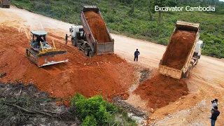 Processing Widening Big Road By Komatsu D65EX Bulldoozer Pushing Soil And Dump Truck Unloading Soil