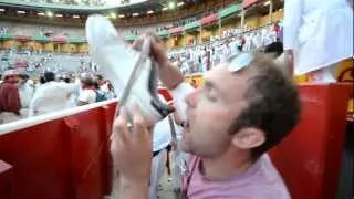 Drinking from a sport shoe in Sanfermin Festival