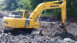 Large rocks slow down the work of an excavator in sand mining - 4k