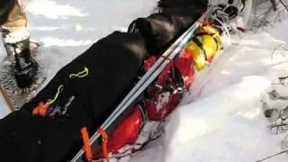 Strapping skis on toboggan sled bags