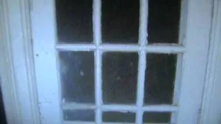 Trans Allegheny Lunatic Asylum ghost face looking in  the side door of building