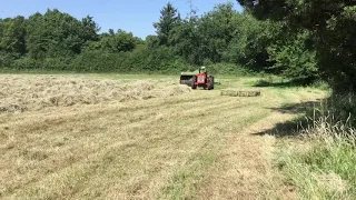 IH 434 tractor baling with large Deutz Fahr baler