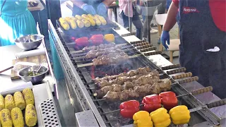 Street Food in Kyiv, Ukraine. Grilled Meat, Fried Fish, Sausages, Noodles, Cheese and more Food