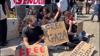 Anti-war demonstrators chain themselves to gate of US office of Palestinian affairs in Jerusalem