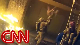 Firefighter catches child tossed from burning building
