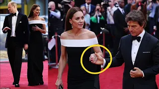 Beaming Kate takes Tom Cruise's hand as she walks the Top Gun: Maverick red carpet