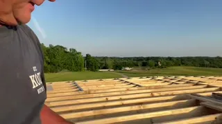 Attaching the wooden roof to the metal shipping container ￼