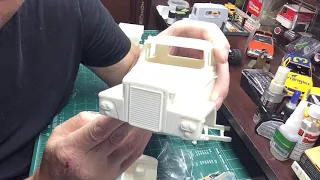 Building scale plastic models: mounting a resin cab to a donor chassis.