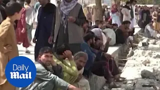 Afghans desperate to flee the country crowd outside the airport