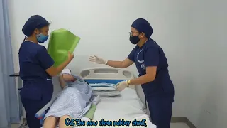 putting and changing draw sheet and rubber sheet of patient