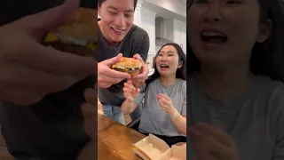 Taking a BIG bite of her burger