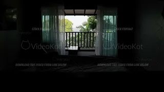 View of cozy hotel room with open balcony and waving winds because of light wind