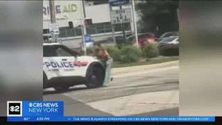 Nassau County Police officer strikes individual waving gun with vehicle