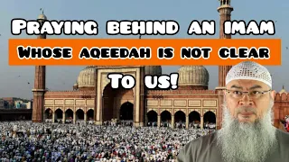 Can we pray behind an imam whose aqeedah is not clear to us? - Assim al hakeem