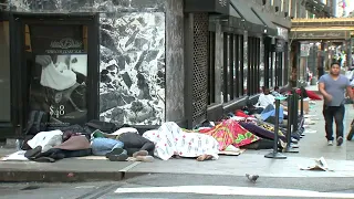 Lines of migrants sleeping outside stretches around Roosevelt Hotel block