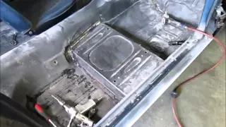 Removing the passenger side floor pan in a 1965 Mustang.