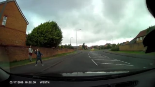 Kid throws rock at car