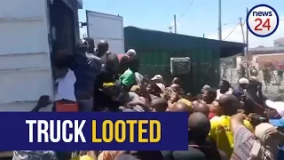 WATCH: Langa residents loot hijacked, abandoned truck