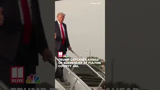 Former President Donald Trump deplanes ahead of surrender at Fulton County Jail